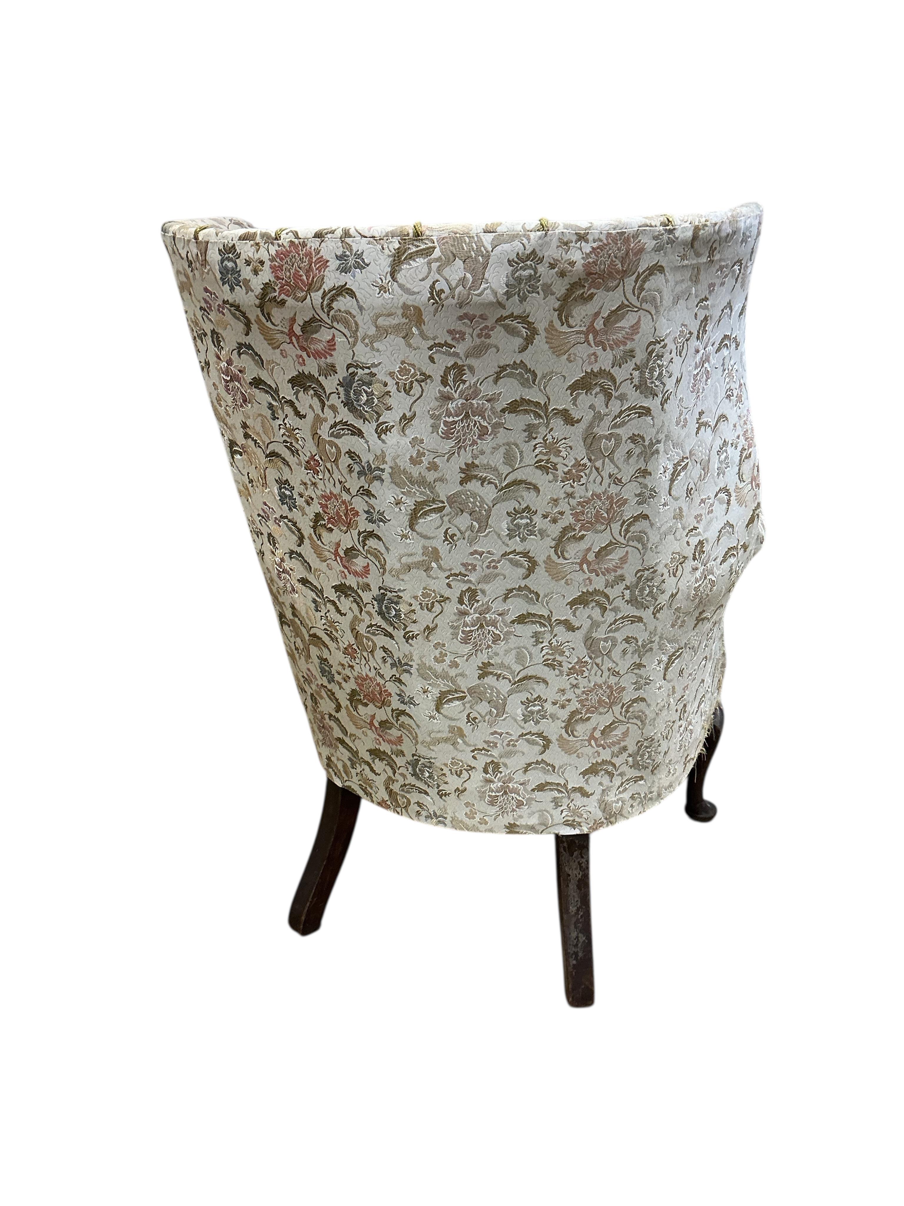 A George II style upholstered barrel-back wing armchair, width 80cm, depth 62cm, height 110cm